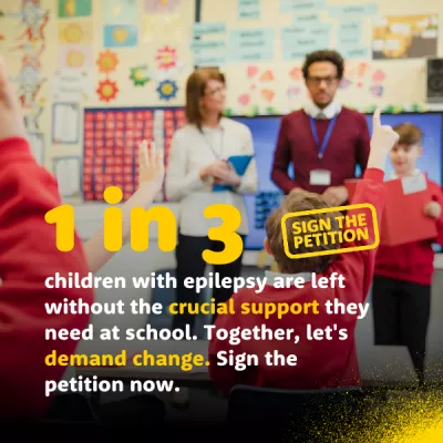 Petition - school classroom with kids hands up and teacher at the front.