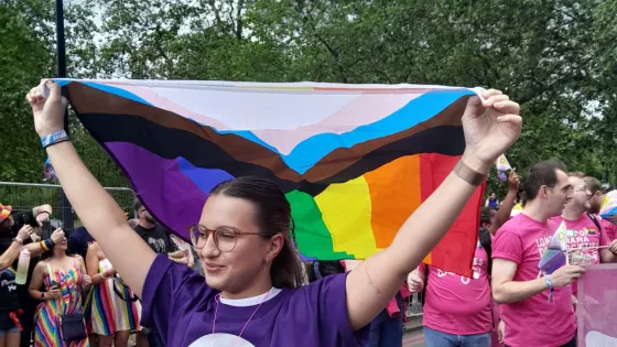 Young woman flying the Pride flag for Young Epilepsy
