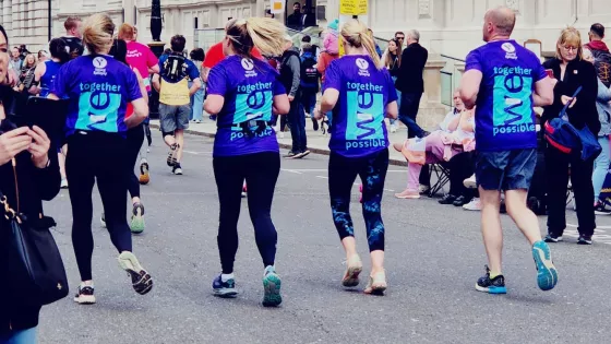 4 runners running away from camera in purple Young Epilepsy Tops