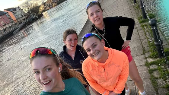 4 Women taking a selfie as they walk along a canal