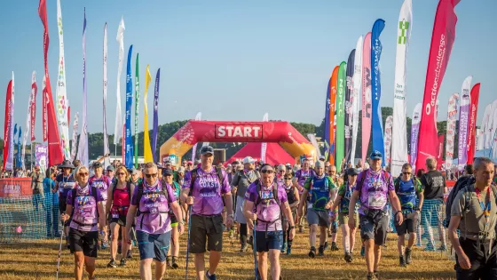 A group of people in purple Jurassic coast ultra challenge t-shirts at the start line