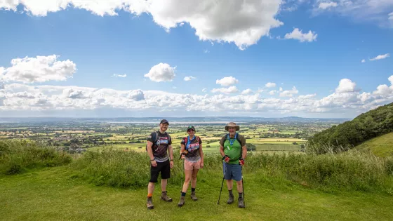 3 walkers pose in the Kent countryside