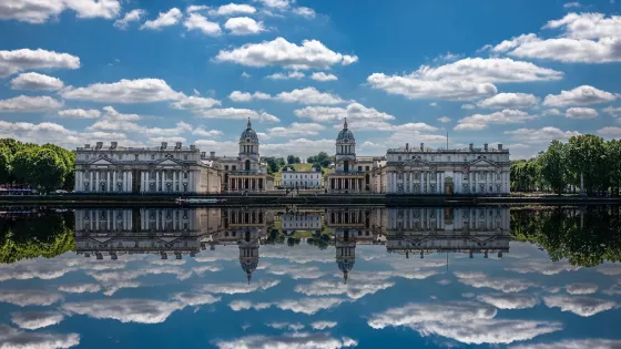 View of water and majestic building with cloud reflection