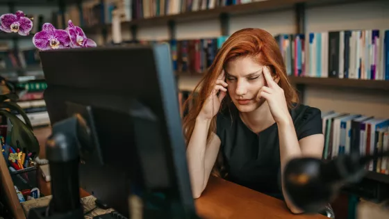 young woman stressed at the computer