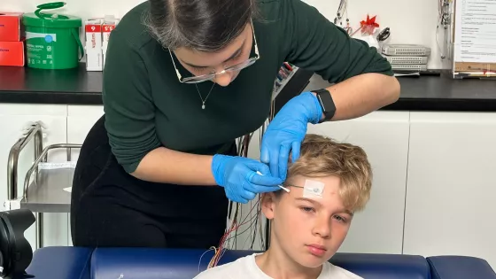 Young boy having electrodes attached to his head for an EEG