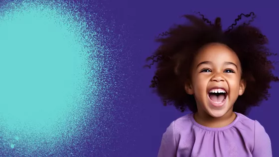 Young girl laughing and posing for Purple Day