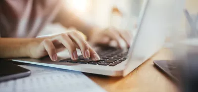 woman typing at a laptop