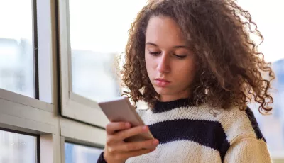 Young girl using her mobile phone