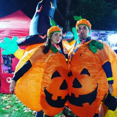 A couple in inflatable pumpkin costumes