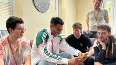 Jay Bothroyd sat down among four young male students of St Piers School and College