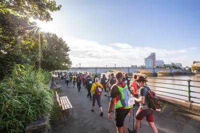 Walkers along the Thames with London views in the background