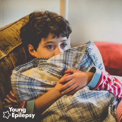 young boy hugging a pillow