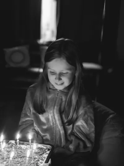 girl blowing out birthday candles