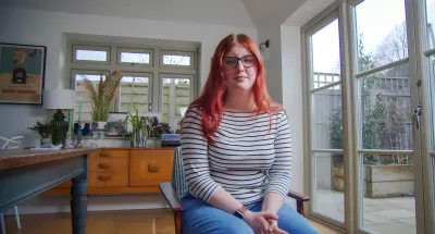 young woman with red hair looking at the camera