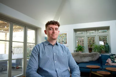 young man sitting smiling at the camera