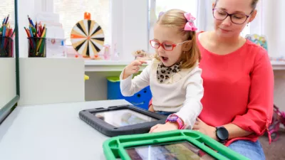 A parent and child looking at a tablet in a school