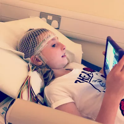 A young girl relaxes whilst having an EEG