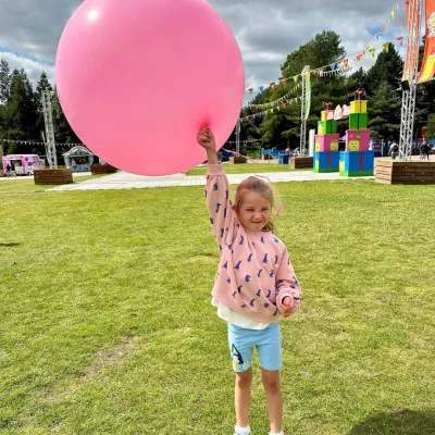 Ivy holding a big pink balloon