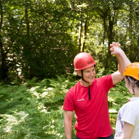 Female student high fives male instructor on out of bounds activity. 