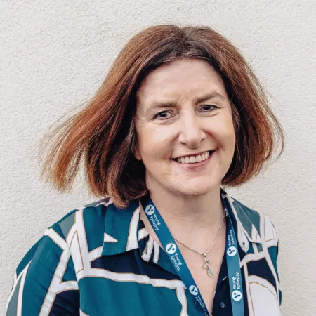 Professional profile photograph of woman smiling at camera