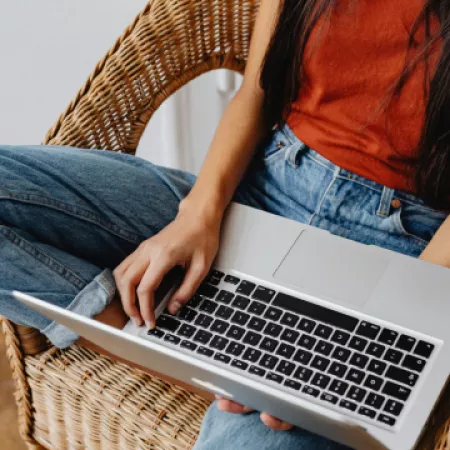 young woman casually relaxing on laptop