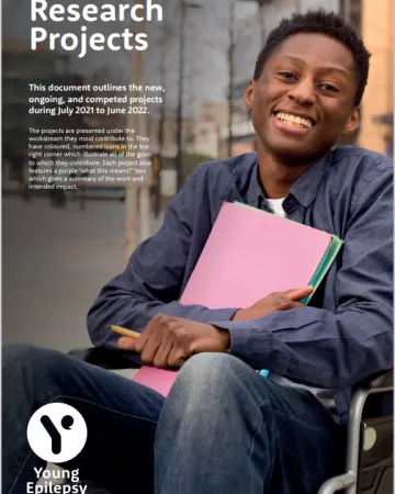 On the Research Projects 2022 cover, a young wheelchair user smiles while holding colourful papers.