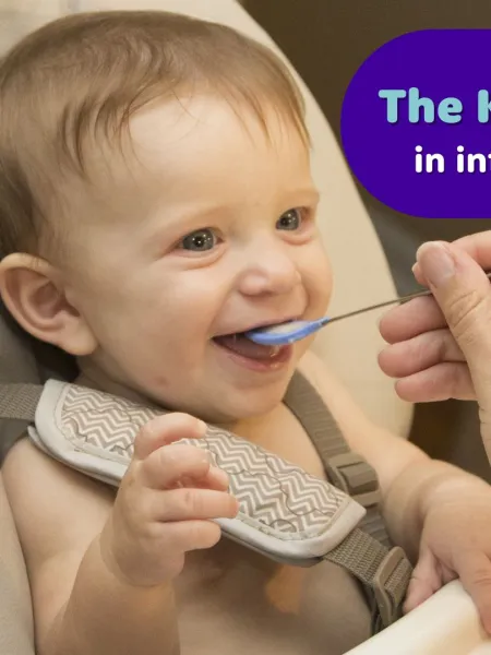 A baby being fed with a small spoon