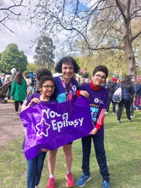 Mum with son and daughter in Purple Young Epilepsy tops with young epilepsy banner