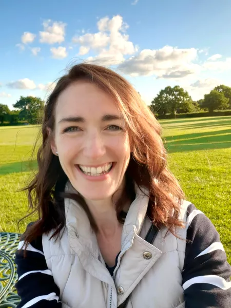 Ann smiling on a field