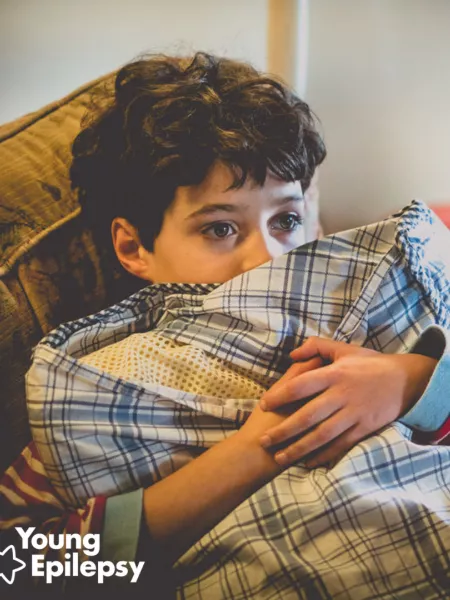 young boy hugging a pillow