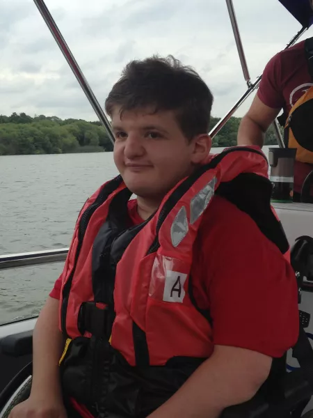 young man on a boat smiling