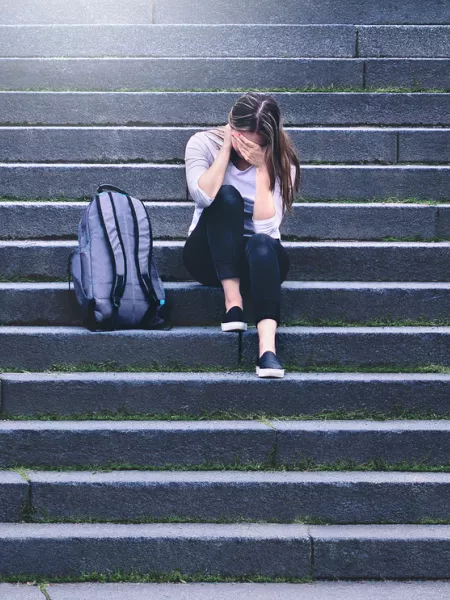 girl sat on the steps sad