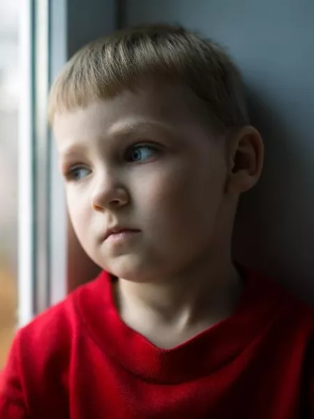 Boy looking out window - Big Give campaign