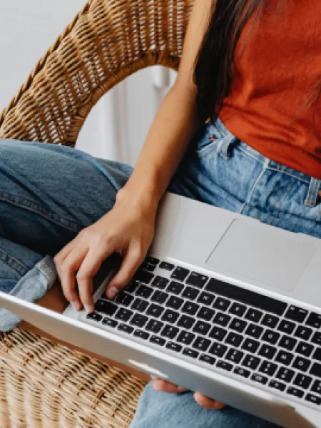 young woman casually relaxing on laptop